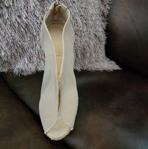 Size 6.5/ 36.5 Red Bottoms. Tan and mesh snake skin.